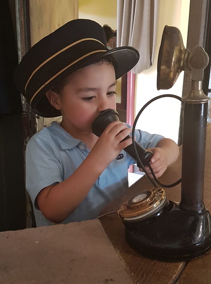 child play answering an antique telephone